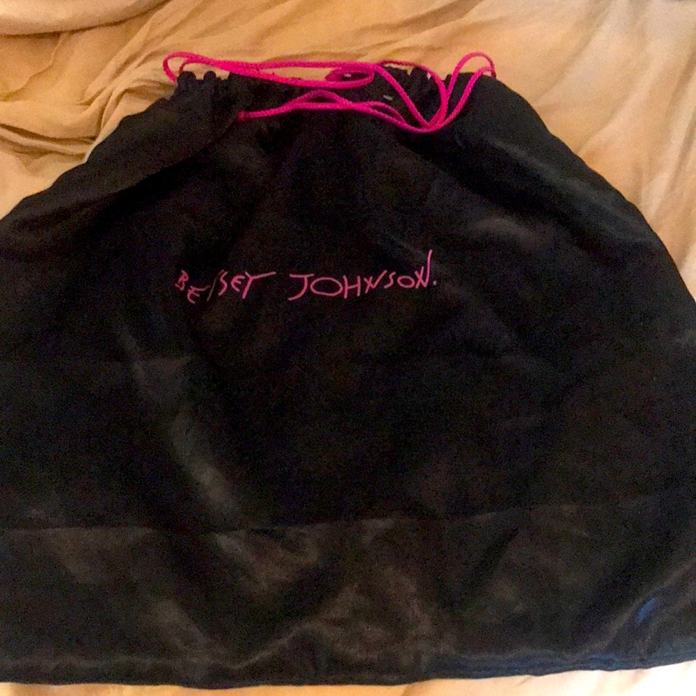 Besty Johnson cover bag in black satin like material with pick pull string .